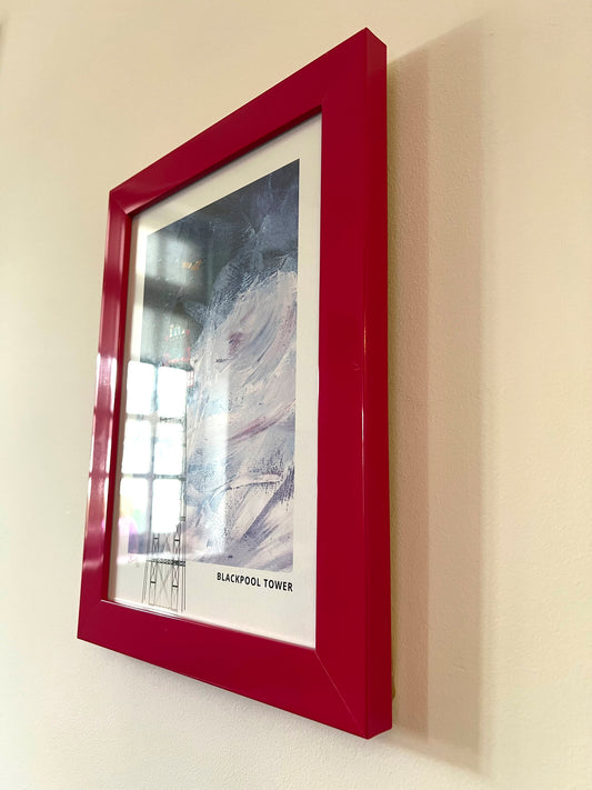 Blackpool Tower seconds framed artwork by Vicki Shortt, the tower rising above the Blackpool seafront, Lancashire, the framed print seen at an angle