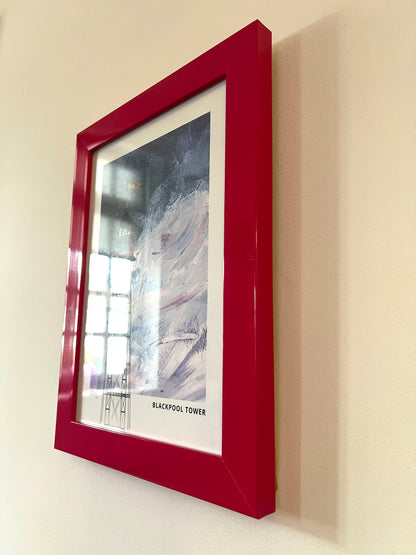 Blackpool Tower seconds framed artwork by Vicki Shortt, the tower rising above the Blackpool seafront, Lancashire, the framed print seen at an angle