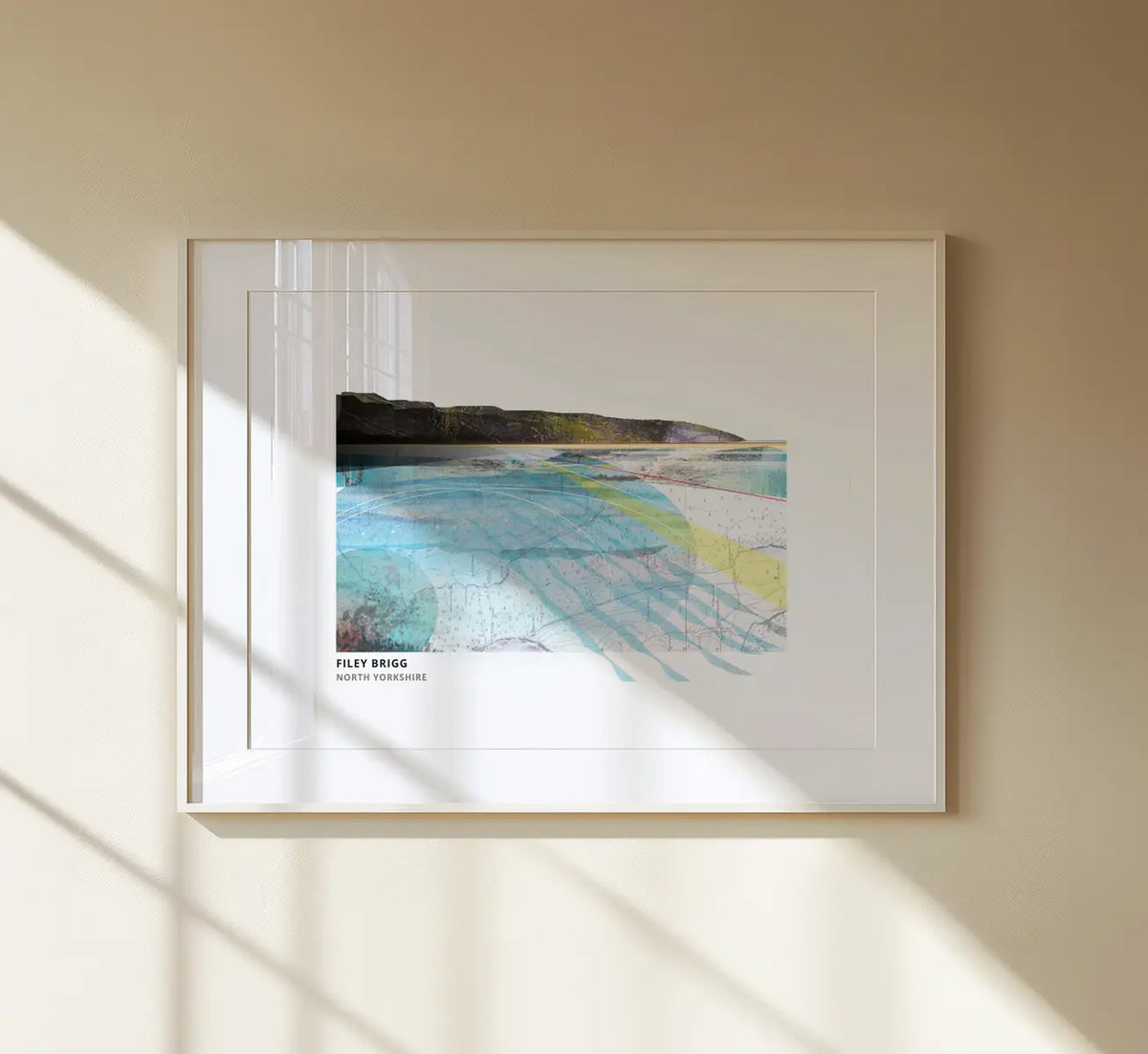 Filey Brigg art print by Vicki Shortt, the rocky spit reaching into the sea at Filey, North Yorkshire, framed in a room setting