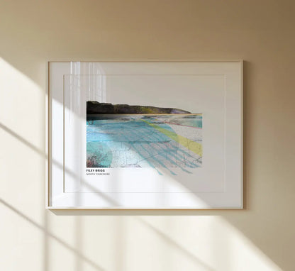Filey Brigg art print by Vicki Shortt, the rocky spit reaching into the sea at Filey, North Yorkshire, framed in a room setting