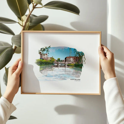 River Welland art print by Vicki Shortt, the river flowing through Stamford against the town's limestone buildings, Lincolnshire, framed in a room setting