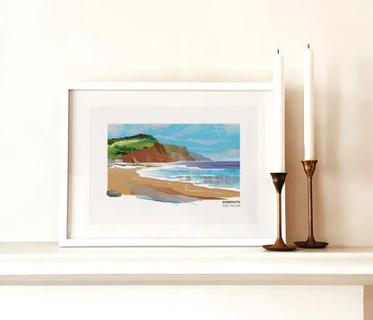 Sidmouth art print by Vicki Shortt, the red cliffs and seafront at Sidmouth, East Devon, framed in a room setting